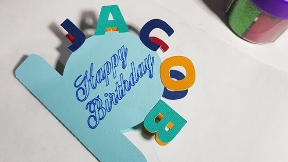 Curved text card with additional letters placed on it