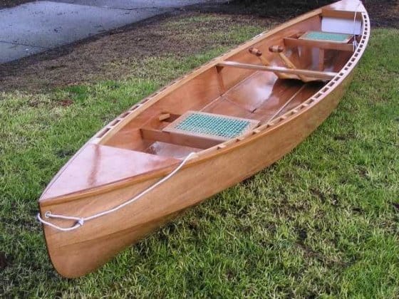 The Eureka 155 Canoe lightweight plywood canoe from plan on grass by the rive
