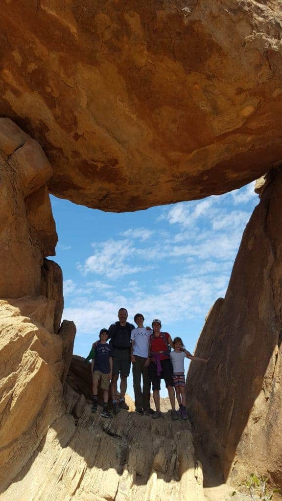 family hiking balanced rock