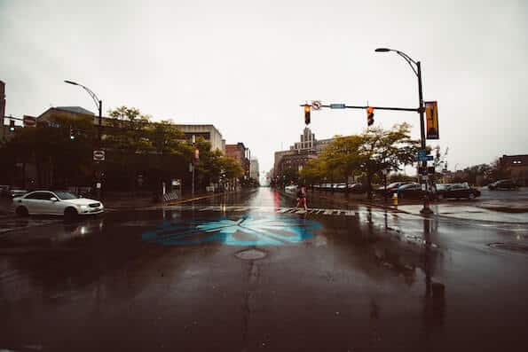 Gloomy Intersection in Rochester New York with Woman in Crosswalk