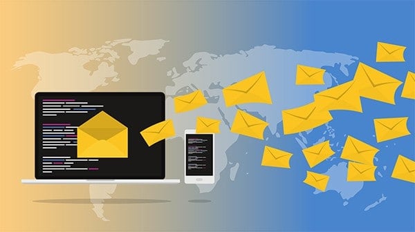 Email marketing illustration on the background of a world map including a desktop and mobile with emails leaving the screen and travelling to recipients.