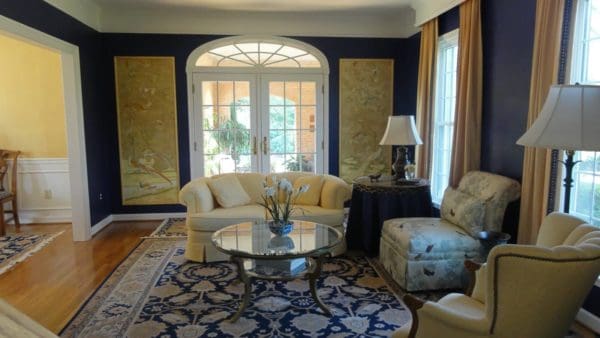 try hanging gold curtains and waverly home classics paintings on beautiful blue living room walls