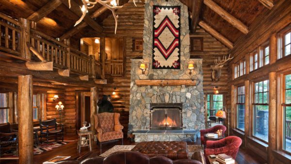 a huge two-level log cabin living room with lots of decorative pieces and art