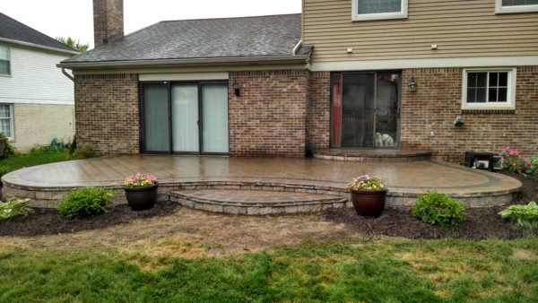 a simple yet stunning raised patio against the house for a lovely blank canvas