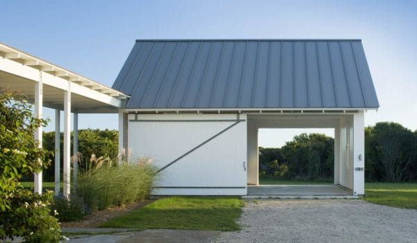 pair a massive sliding barn style garage door in crisp white with englert slate gray metal roof