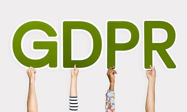 Four arms, each holding a letter of GDPR.