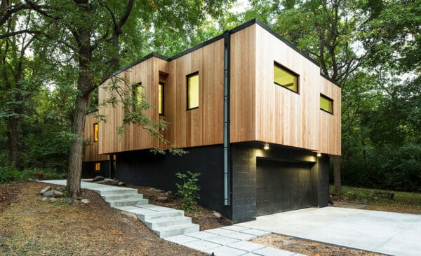 use a black-stained foundation with clear vertical cedar siding to make your house look like it’s floating