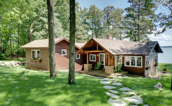 consider using log accents to flank your log cabin front door for a timeless patio appeal