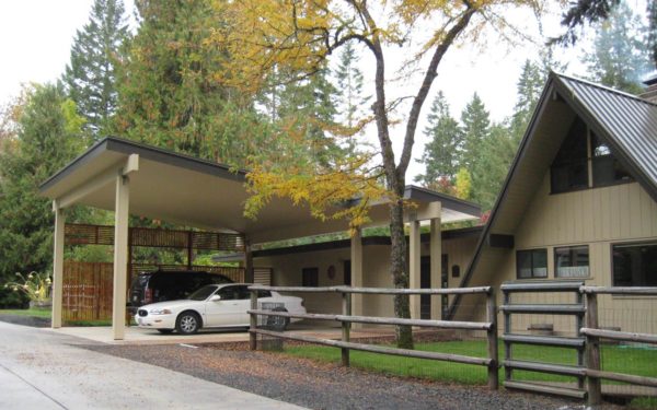 complement the front of an a-frame house with a simple slanted carport