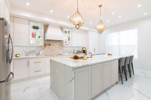 this glamorous white tile kitchen floor pairs antique pendant lights with marbled surfaces