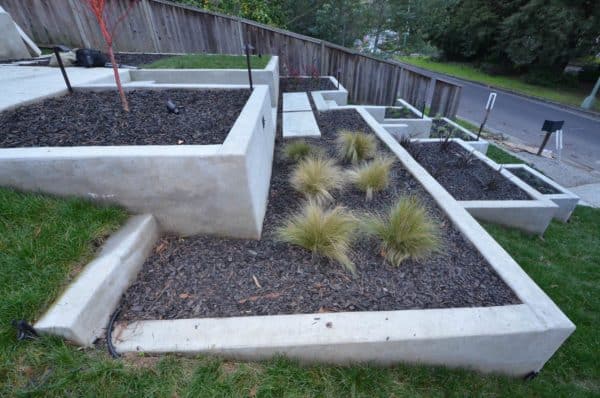 create a multi-level garden and concrete retaining wall for a unique and refreshing front yard