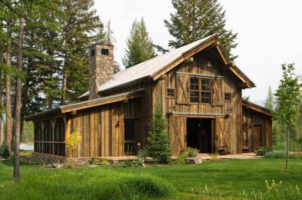 go all out on natural wood textures for a pastoral home with barn-style door and window shutters