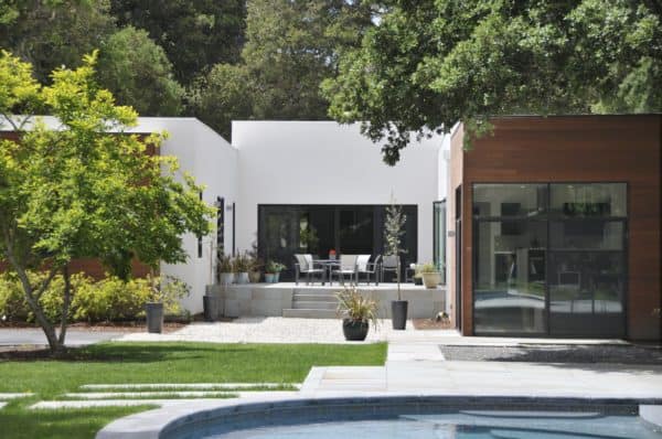 contemporary wood home exterior featuring a trendy raised patio against the house