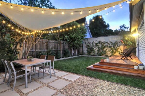 plant bougainvillea vines on your backyard wall and hang an overhead canvas for a cozy contemporary space