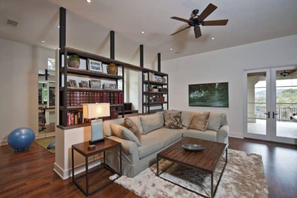 half wall industrial bookshelf divider with antique books for a traditional and homey family room