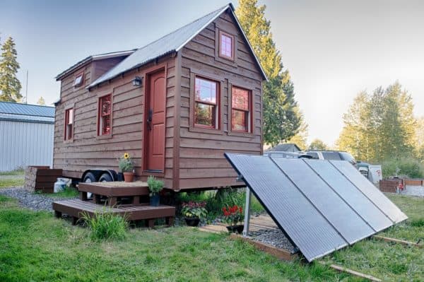 classic red door in a mountain inspired tiny home that exudes cottage cosiness and charm