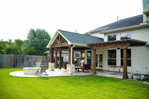 try stamped concrete on a covered patio with a fire pit and cedar pergola for a gorgeous traditional space