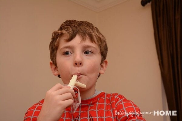 Joshua eating Marvel Spider-Man String Cheese