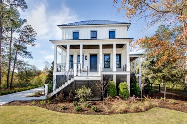 a classy traditional white house exterior accentuated with dark black windows