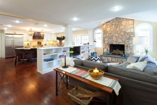 white custom shelving as room divider to keep the open feeling