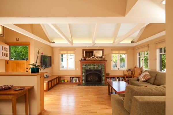 emerald green tile front of fun mosaic fireplace in a historic-style homey living room