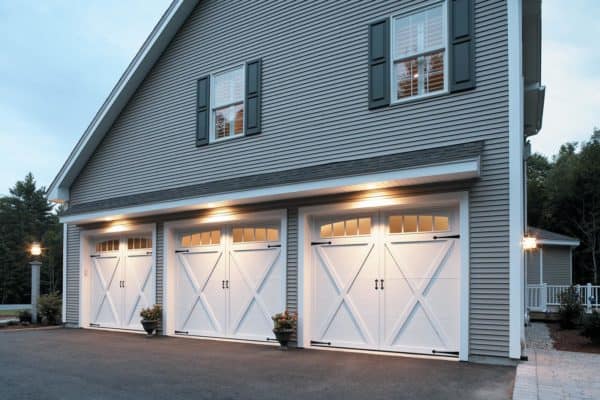 large white barn style garage doors on a gorgeous farmhouse design