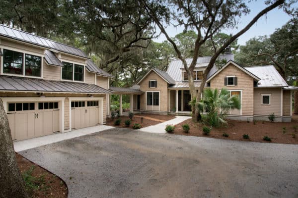 beach style house featuring a detached garage and breezeway with classic wood exterior