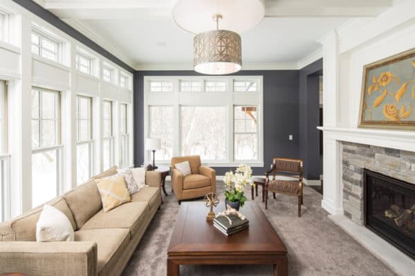 create an exquisite living room featuring gray and white walls and massive floor-to-ceiling windows