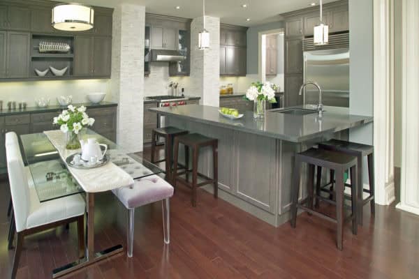 go for a contemporary charm with grey-stained kitchen cabinets and stunning glass dining table