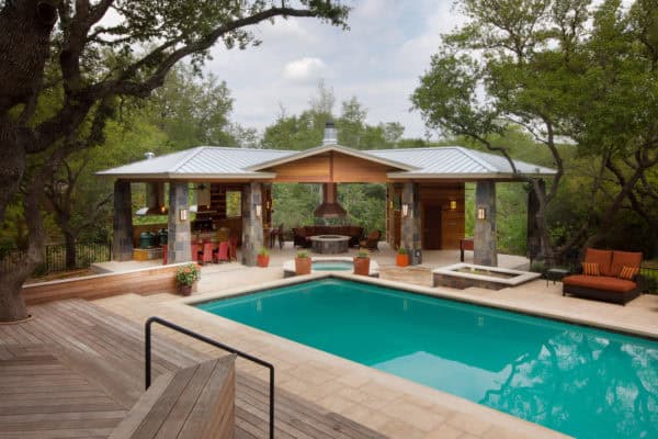 try a c-shaped pavilion around a fire pit for a cozy pool house with bathroom