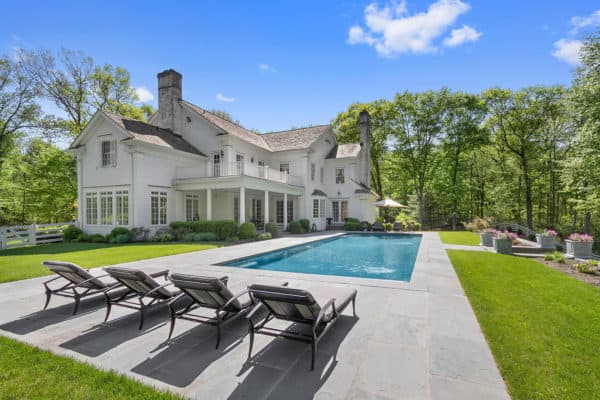 can’t go wrong with a simple rectangular pool and stamped concrete deck to complement a colonial home exterior