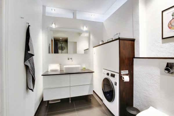 mix wood and white walls for an elegant bathroom and laundry room combo