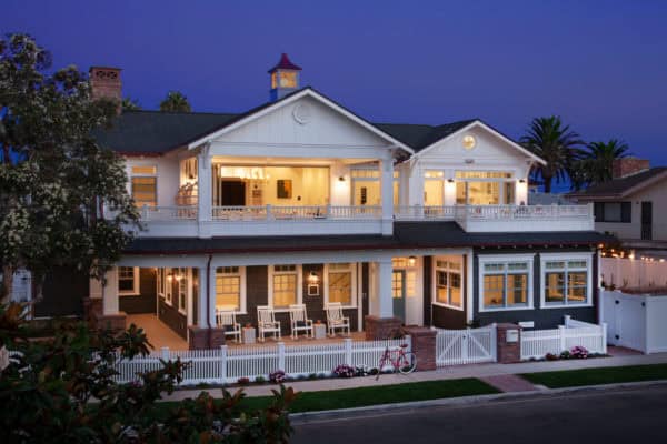 use bifold doors to blend second-story deck and indoor living space in this beach-style home