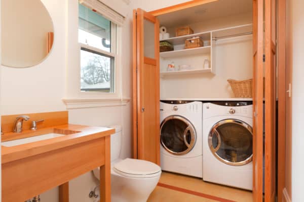 use wooden bifold doors to hide washer dryer for a stylish bathroom laundry combo