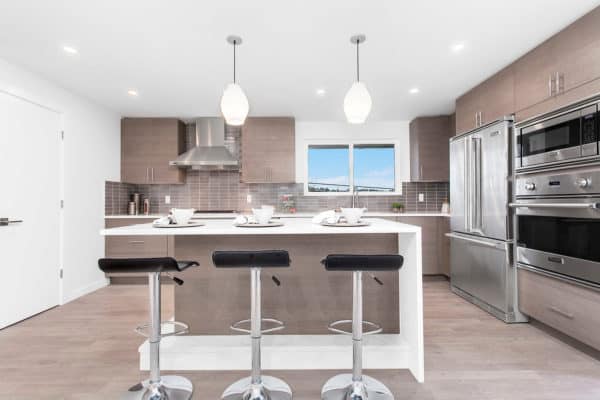 choose a trendy kitchen remodel featuring brown medium toned wood flooring and classic white walls