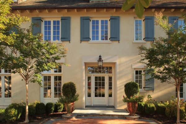 choose the french country style house with carolina gull shutters and lush trees