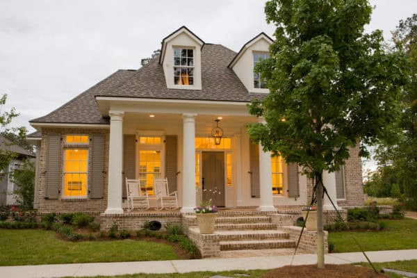 elegant tuscan-styled house with keystone grey shutters and pearly white paint