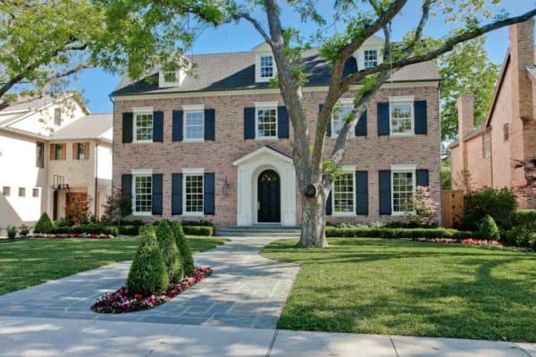 evoke classic old-school charm through this brick exterior and navy shutter color