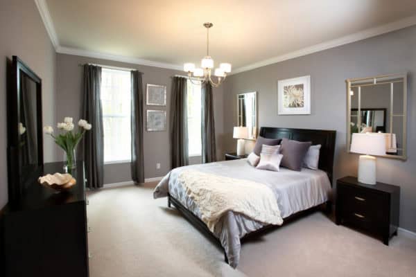 pair warm grey colors and black furnishing with deep brown tones for a comfy bedroom