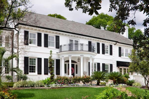 play with monochromatic contrasts of white brick and satin black shutters for traditional and timeless