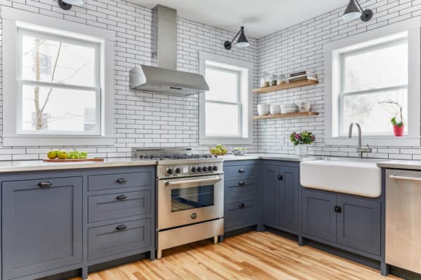 bring together custom blue cabinets and subway tile with black grout walls in a modern l-shaped kitchen