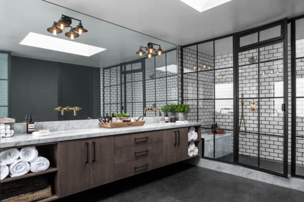 try an industrial bathroom featuring subway tile with black grout shower walls and marble countertops