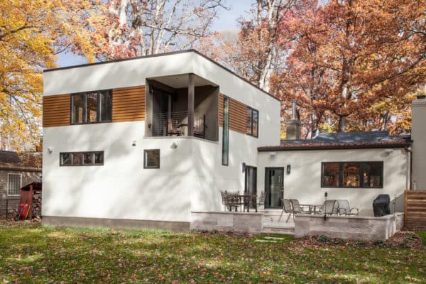 consider modern architecture featuring this raised back patio against the house