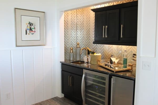 this all-black small wet bar works well amidst similar contemporary and modern interior ideas