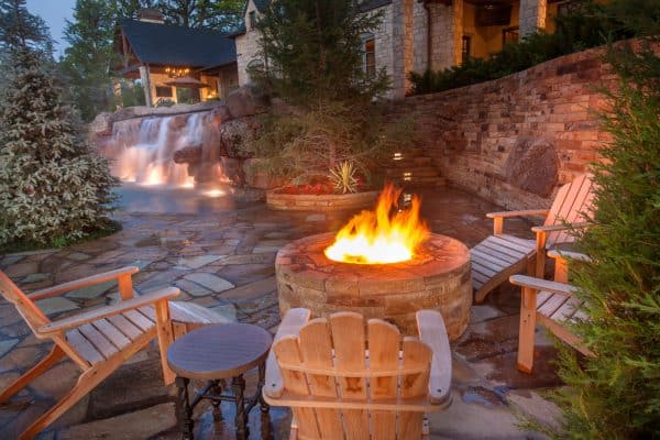 complement your retaining wall fire pit with a lavish water feature for the ultimate backyard design