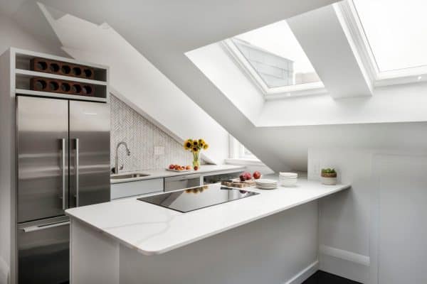 scandinavian-inspired small kitchen with peninsula embraces all-white decor and furnishing