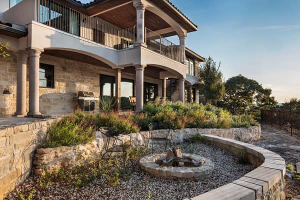 this craftsman inspired retaining wall fire pit with multiple levels creates a stunning and layered curb appeal