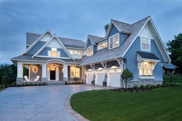 this charming blue-gray house uses sherwin williams storm cloud fuses traditional and modern architecture