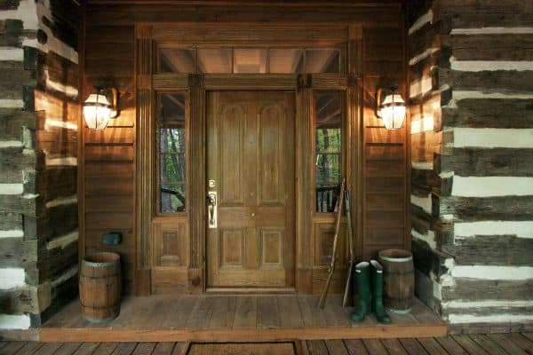 this log cabin looks quintessentially rustic with a medium wood front door