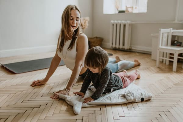 Personal training from home - Mother and daughter exercising together at home.